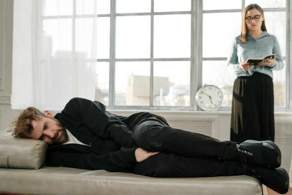 Man in Black Jacket Lying on Bed and taking cognitive processing therapy